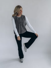 Angi trägt LIV geschlossen über einem weißen Longsleeve; die hüftlange, gerade Passform ist vollständig sichtbar.